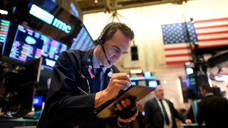 In this file photo, a trader works during the closing bell at the New York Stock Exchange on March 3, 2020, on Wall Street in New York City.