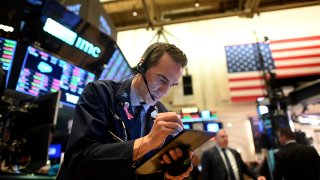 In this file photo, a trader works during the closing bell at the New York Stock Exchange on March 3, 2020, on Wall Street in New York City.