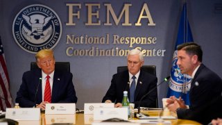 President Donald Trump, left, and Vice President Mike Pence listen as Acting Secretary of Homeland Security Chad Wolf speaks during a teleconference with governors at the Federal Emergency Management Agency headquarters on March 19, 2020, in Washington, DC.