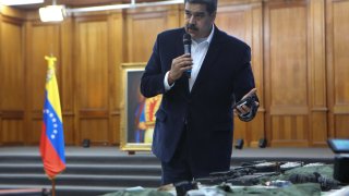 Venezuelan President, Nicolas Maduro displays seized armament and passports after a meeting with members of the Armed Forces in Caracas, Venezuela on May 4, 2020. Venezuela's President Nicolas Maduro confirmed the detention of two US "mercenaries" among 13 attackers involved in Sunday's two failed maritime raids.