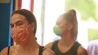 Voters wearing face masks are seen waiting in line to cast their votes during Indiana Primary Election Day their votes