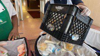 Free meals offered by the Board of Education of the City of New York are prepared for distribution at a school during the Coronavirus pandemic