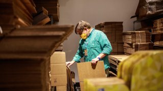 Legacy Toys Store Manager Jeff Kasper sorts through shipping boxes at the store in the Mall of America on June 16, 2020 in Bloomington, Minnesota.