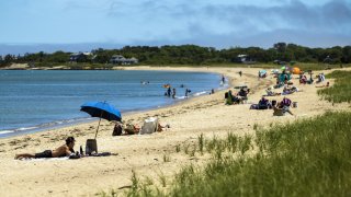 People sit on the beach on Martha's Vineyard in Oak Bluffs, Massachusetts, U.S., on Thursday, June 18, 2020.