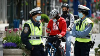 Bicyclists and NYPD traffic officers are seen during the coronavirus pandemic on May 14 2020 in New York City.
