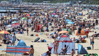 Tourists enjoy the hot weather at the beach in Bournemouth, U.K.