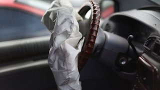 A deployed airbag is seen in a Chrysler vehicle