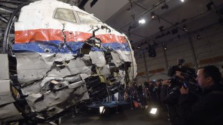 In this file photo, the wrecked cockpit of the Malaysia Airlines flight MH17 is presented to the press during a presentation of the final report on the cause of the its crash at the Gilze Rijen airbase October 13, 2015.