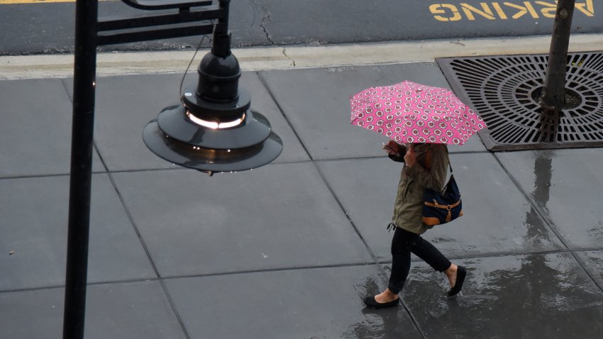 woman walks with umbrella