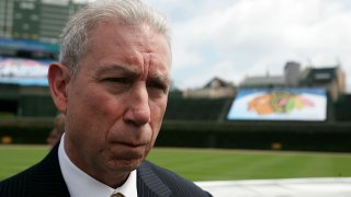 Blackhawks President John McDonough speaks with reporters at Wrigley Field in 2008