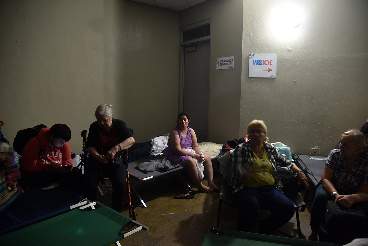 People take shelter at Roberto Clemente Coliseum in San Juan, Puerto Rico, on Sept. 20, 2017, during the passage of Hurricane Maria.