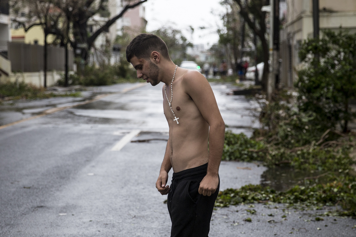 A man ventures out in the Miramar neighborhood after Hurricane Maria made landfall on Sept. 20, 2017, in San Juan, Puerto Rico. Thousands of people have sought refuge in shelters, and electricity and phone lines have been severely effected.