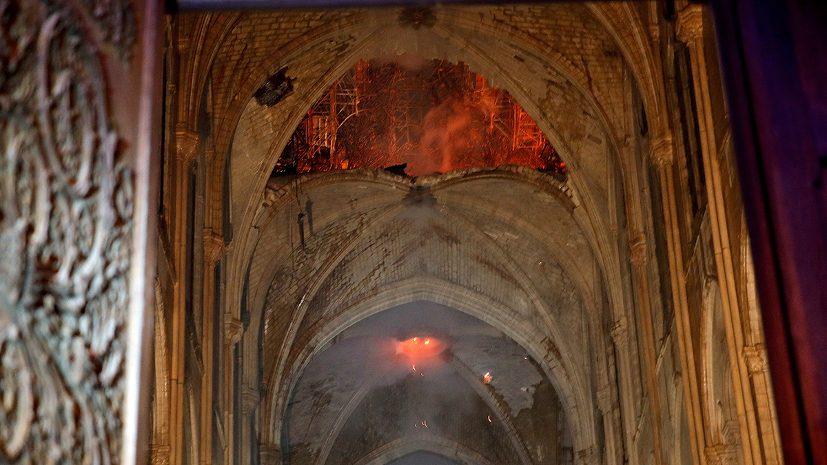 Flames and smoke are seen as the interior at Notre Dame cathedral in Paris, Monday, April 15, 2019.