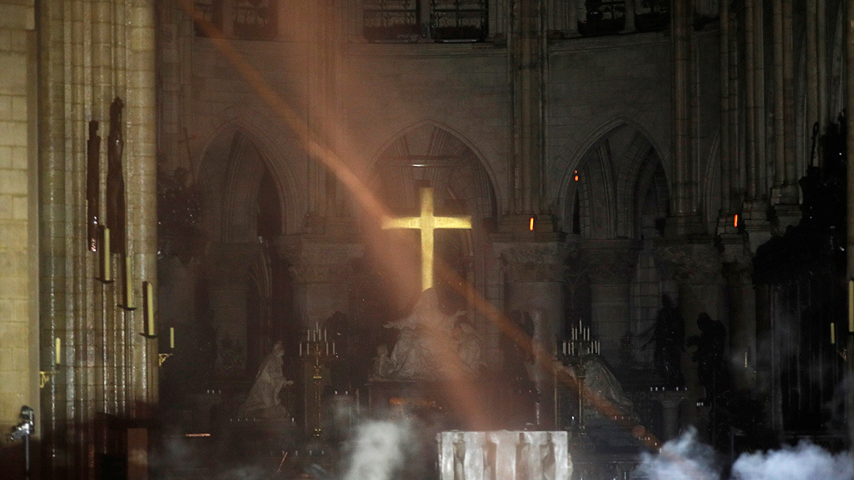 Smoke is seen around the alter inside Notre Dame cathedral in Paris, Monday, April 15, 2019.