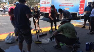 Community members seen cleaning up after the protests