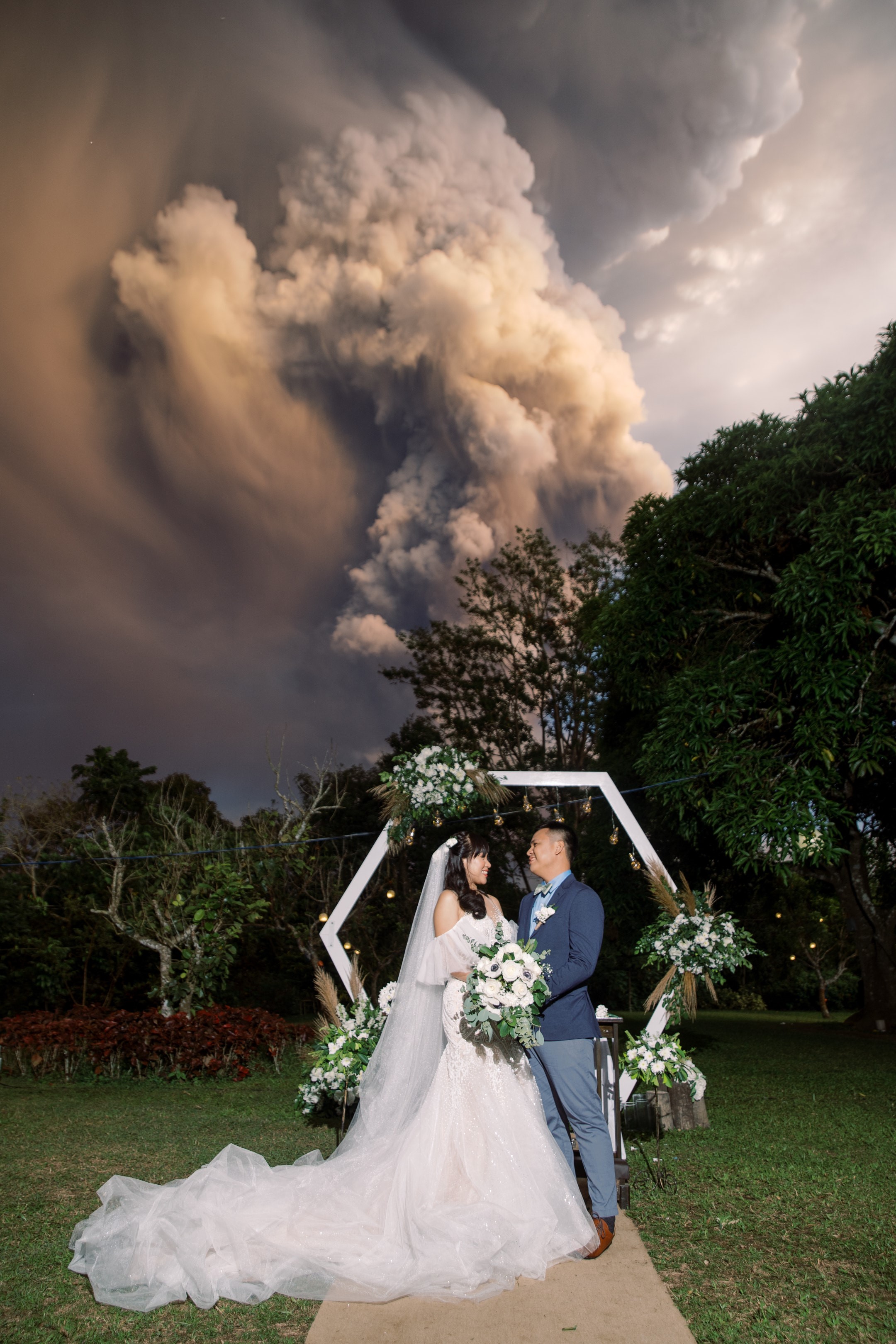 A couple take their wedding photos right as the Taal volcano erupts behind them, on Jan. 12, 2020, in Tagaytay, Philippines. (Courtesy Randolf Evan Photography)