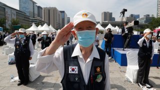 South Korea veterans salute during a ceremony to unveil an art installation to commemorate the upcoming 70th anniversary of the Korean War, in Seoul, South Korea, Monday, June 15, 2020. South Korea on Sunday convened an emergency security meeting and urged North Korea to uphold reconciliation agreements, hours after the North threatened to demolish a liaison office and take military action against its rival.