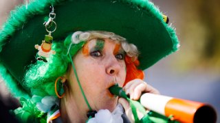 A woman dressed in colors matching the Irish flag partook in the St. Patrick’s Day parade passing through central London on March 13, 2016 in London, England.