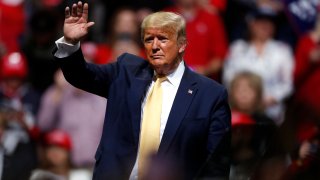 In this Feb. 20, 2020, file photo, President Donald Trump waves at a campaign rally in Colorado Springs, Colo.