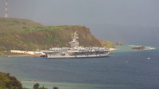 The aircraft carrier USS Theodore Roosevelt is docked at Naval Base Guam in Apra Harbor amid the coronavirus pandemic, April 27, 2020.