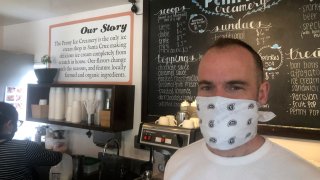 In this April 17, 2020, photo, Zachary Davis poses for a photo at The Penny Ice Creamery in Santa Cruz, Calif.
