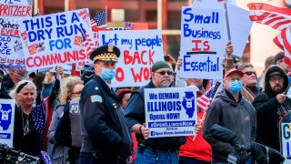 People participate in a reopen Illinois rally and protest outside the James R. Thompson Center that houses offices of the Illinois state government in Chicago, Illinois, USA, 01 May 2020. EFE/Tannen Maury