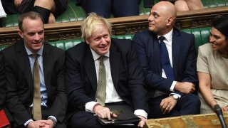 In this photo made available by the UK Parliament, Britain’s Prime Minister Boris Johnson, center, attends the debate in the House of Commons, London, on Dec. 19, 2019.