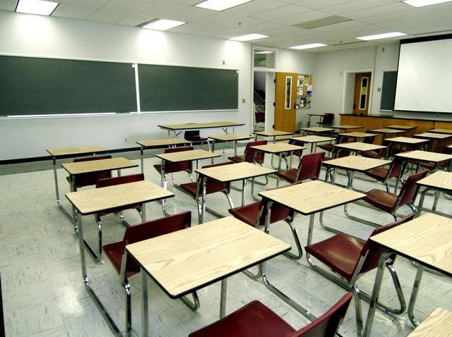 This image shows a generic classroom with desks and a chalkboard.