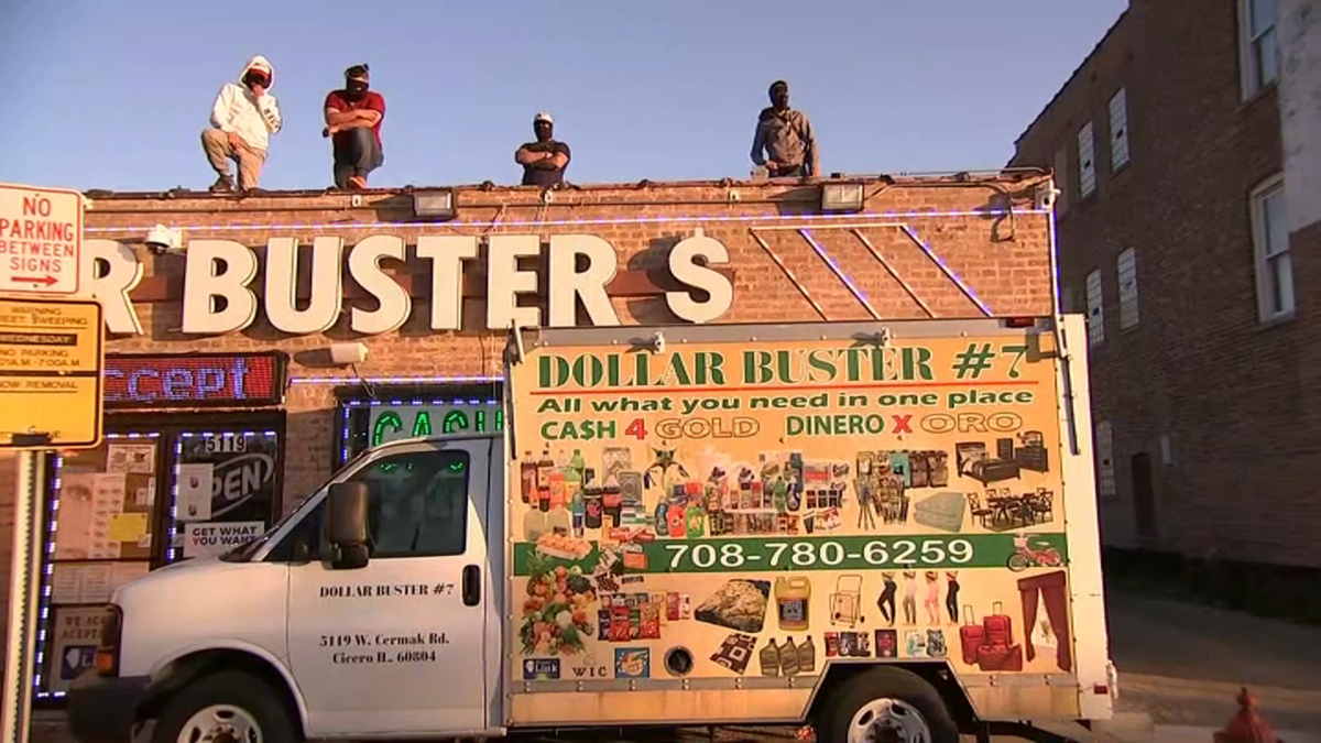 Armed Employees Keep Watch From Roof Of Store Amid Looting In