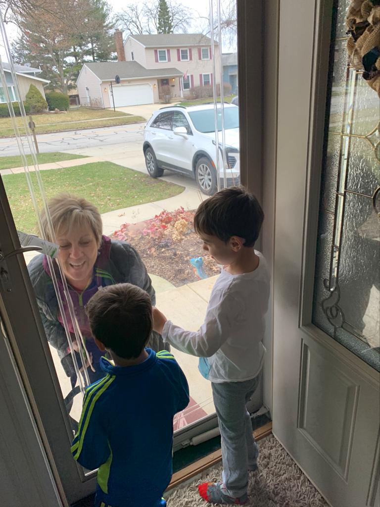 This is a picture of an ER nurse at Edward Hospital visiting her grandchildren behind the glass door.  Social distancing since she can’t be in contact with them.  I thought it was so telling of the times I wanted to submit it for my friend.