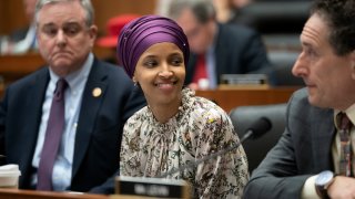 In this file photo, Rep. Ilhan Omar, D-Minn., sits with fellow Democrats, Rep. David Trone, D-Md., left, and Rep. Mike Levin, D-Calif., right, on the House Education and Labor Committee during a bill markup, on Capitol Hill in Washington, Wednesday, March 6, 2019.