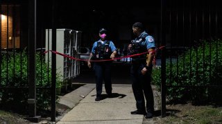 Chicago police investigate the scene where multiple people were shot in the 7600 block of South Loomis in the parking lot of a apartment complex, Wednesday, June 17, 2020.
