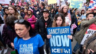 In this Feb. 18, 2017, file photo, thousands of people take part in the "Free the People Immigration March," to protest actions taken by President Donald Trump and his administration, in Los Angeles. A federal appeals court has given the Trump administration a rare legal win in its efforts to crack down on sanctuary cities.
