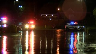 Police positioned outside a hotel in Rockford during a standoff with a shooting suspect