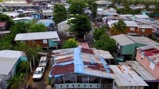 The blue tarp that was used to protect the roof damaged by Hurricane Maria two years ago is showing wear and tear