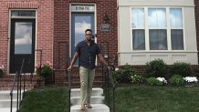 Akili Akridge in front of his Maryland townhome.