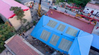 rescue workers are seen near the site of a collapsed two-story restaurant in Xiangfen County of Linfen City, northern China's Shanxi Province, Saturday, Aug. 29, 2020