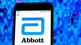 In this photo illustration, the Abbott Laboratories Pharmaceutical company logo seen displayed on a smartphone.