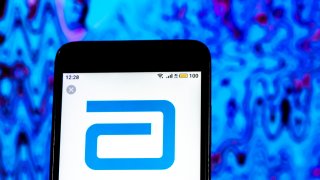 In this photo illustration, the Abbott Laboratories Pharmaceutical company logo seen displayed on a smartphone.