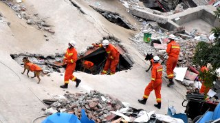 Rescuers search for survivors in the rubble of a collapsed hotel on March 8, 2020 in Quanzhou, Fujian Province of China