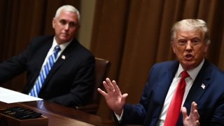 US President Donald Trump speaks next to US Vice President Mike Pence(L) before signing an Executive Order on Hiring American at the White House on August 3, 2020 in Washington,DC. - The Executive Order follows his Buy American, Hire American Executive Order from April 2017 and takes further action to prevent Americans from being displaced by foreign workers.