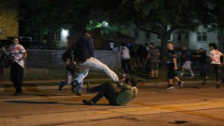 Clashes between protesters and armed civilians, who protect the streets of Kenosha against the arson, break out during the third day of protests over the shooting of a black man Jacob Blake by police officer in Wisconsin
