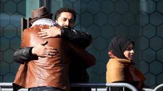 Survivors and family members of the 2019 twin mosque shootings greet each other outside the High Court building on the last day of the sentencing hearing for Brenton Tarrant, the gunman who massacred 51 people during the attacks, in Christchurch on August 27, 2020.