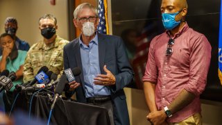 Tony Evers and Mandela Barnes stand at a podium and host a press conference on the protests in Kenosha.