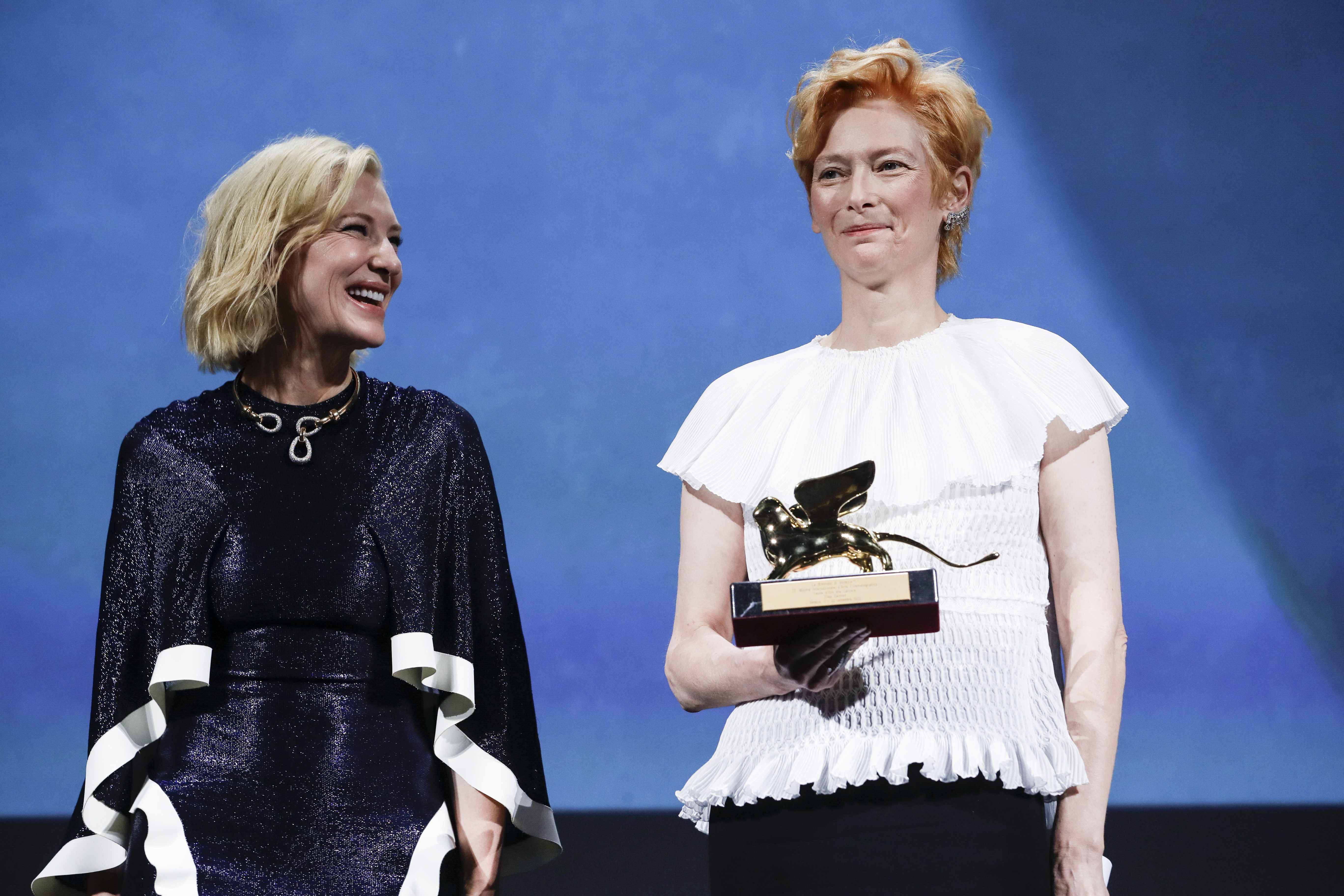 Actress Tilda Swinton, right, holds the Golden Lion for Lifetime Achievement, which was presented by Jury President Cate Blanchett