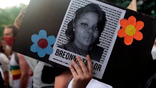 A demonstrator in Denver, Colorado, holds a sign with the image of Breonna Taylor, a Black woman who was fatally shot by Louisville Metro Police Department officers, during a protest against police brutality, June 3, 2020.