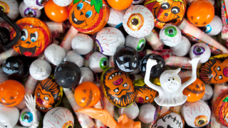 A pile of Halloween choclates and toys.
