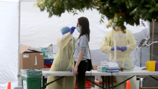 OAKLAND, CA - SEPTEMBER 15: A woman gets tested at a Covid-19 test site at Madison Park in downtown Oakland, Calif., on Tuesday, Sept. 15, 2020. Asian Health Services has partnered with Alameda County to manage the site, which offers services in 12 languages.