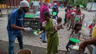 Indian homeless people stand in queue to receive free food distributed by the Sikh community near a railway station in Gauhati, India, Sunday, Sept. 6, 2020. India's coronavirus cases have crossed 4 million, leading the world in new infections and deepening misery in the country's vast hinterlands where surges have crippled the underfunded health care system.