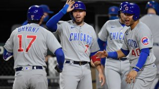 Cubs players congratulate Kris Bryant after he hits a grand slam against the White Sox